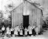 1889 Photo of Flora McFarlane with her students infront of the school house
